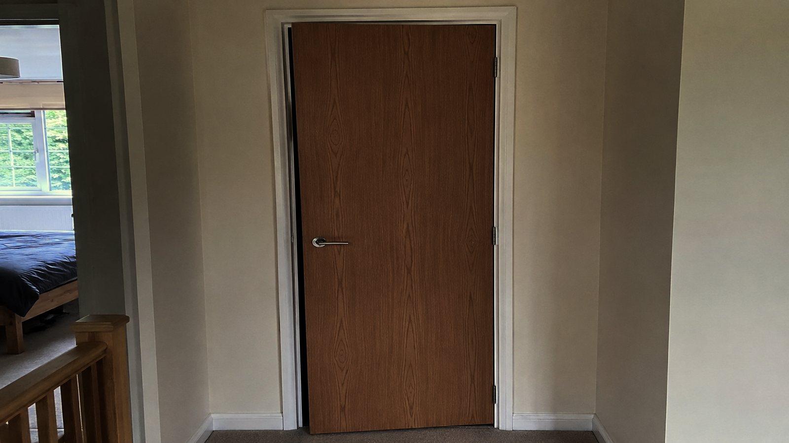 An internal door stopped against its frame with an uneven gap down the edge