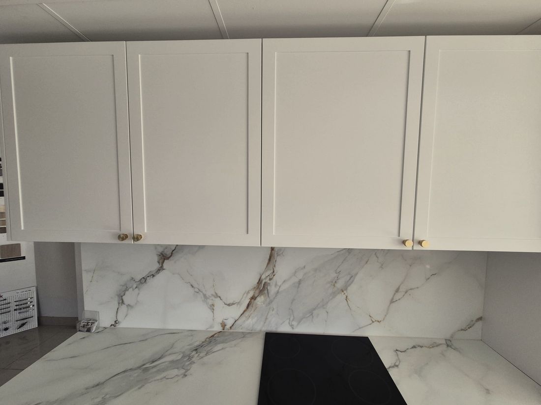 Overhead kitchen cabinets and a marble look splashback on a job in south west Sydney