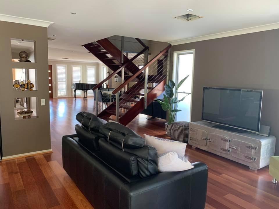 A finished living room with walls, ceiling and trim repainted throughout