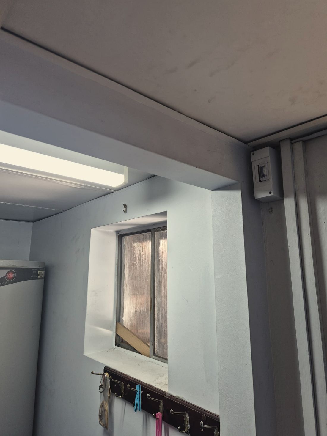A utility room with walls, beam and bulkhead painted in one soft grey