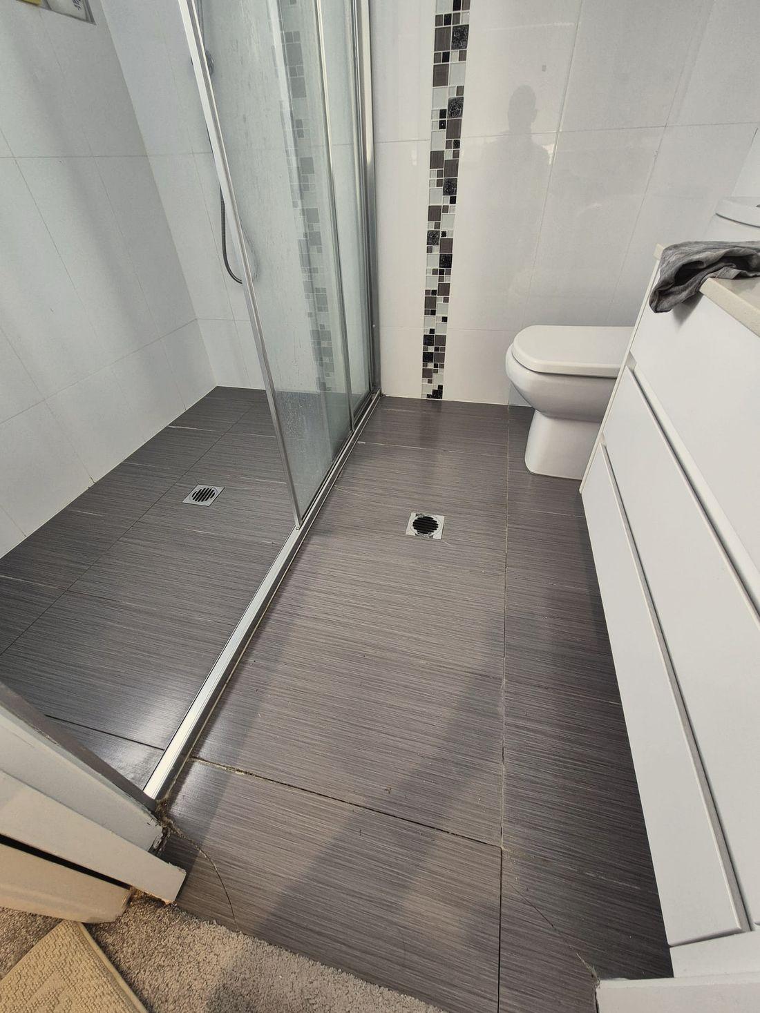 A tiled bathroom with the shower screen and vanity in place