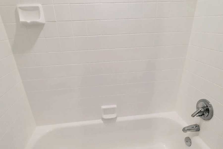 The same wall and bath in white after resurfacing